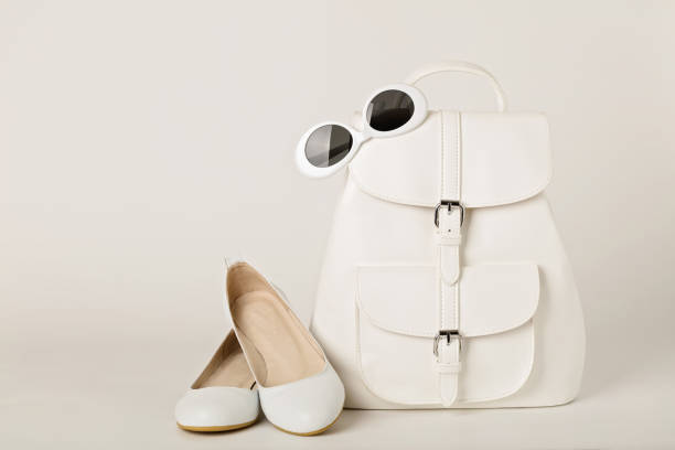 istock White female backpack, shoes and sunglasses on a white background. 902548620