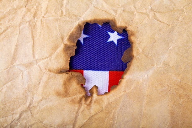 istock Burned old paper and American flag, as background 902549166