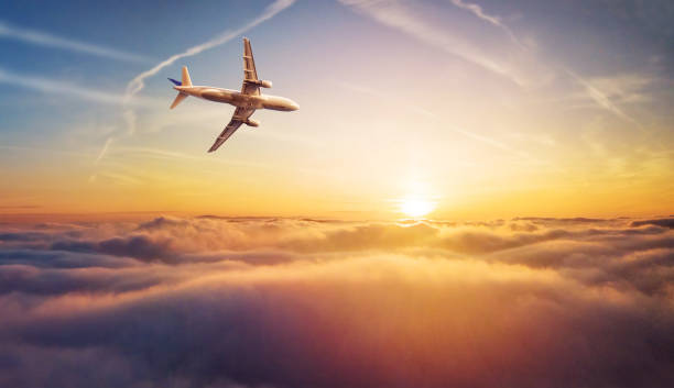 istock Commercial airplane jetliner flying above clouds in beautiful sunset light. 902554212