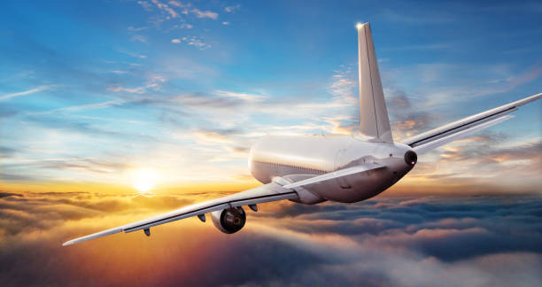 istock Commercial airplane jetliner flying above clouds in beautiful sunset light. 902554308