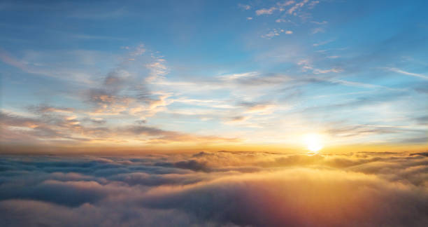 istock Beautiful aerial view above clouds with sunset 902554410