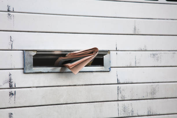 istock Daily newspaper sticking through a letterbox 902565510