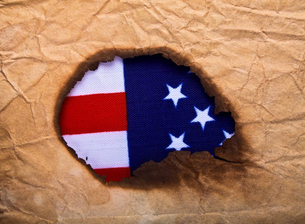 istock Burned old paper and American flag, as background 902568028
