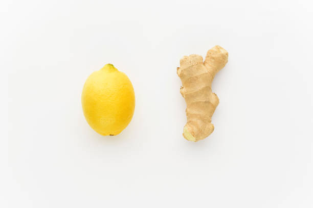 istock minimalism lemon and ginger on a white background. concept of increasing immunity in winter 902568726