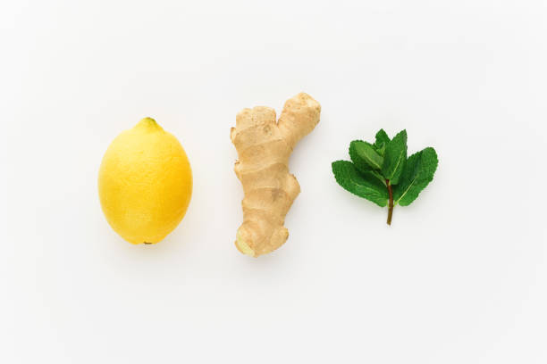 istock minimalism lemon and ginger on a white background. concept of increasing immunity in winter 902568742