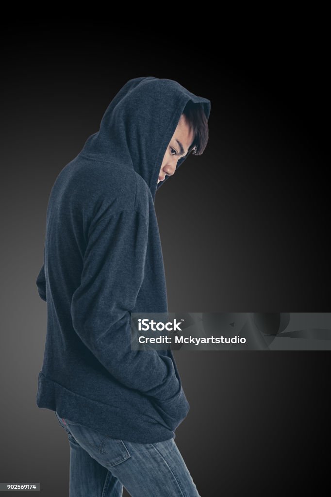 The mysterious man The mysterious man posing with grey hoodie on a black background, Have clipping paths. Adult Stock Photo