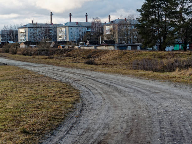 istock Dirt road in poor countryside 902573040