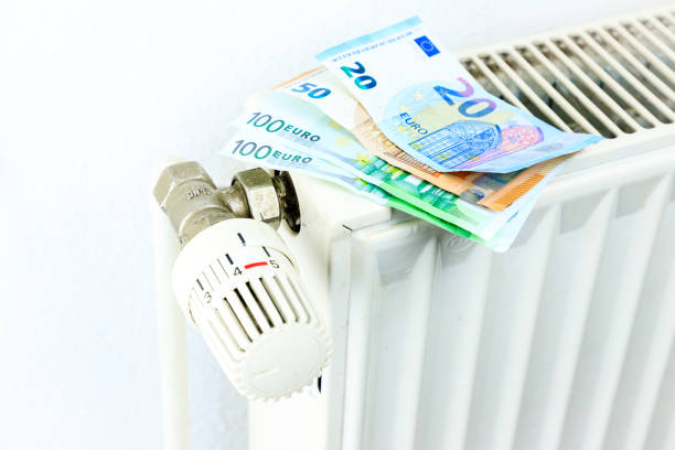 istock Money on a radiator symbolizes the expensive heating costs 902576104