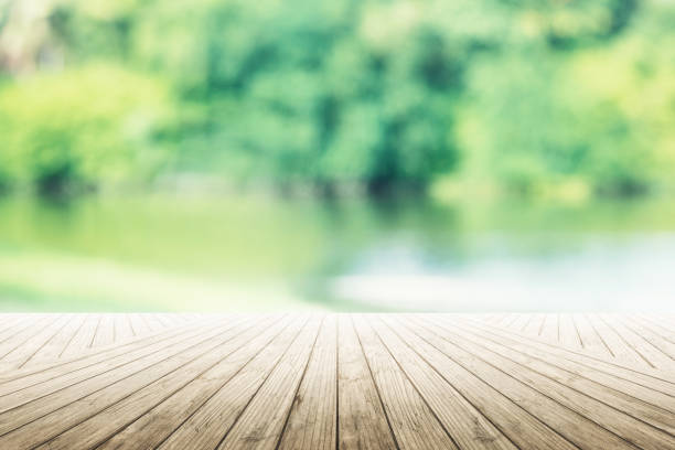 istock Empty wooden table with party in garden background blurred. 902579262