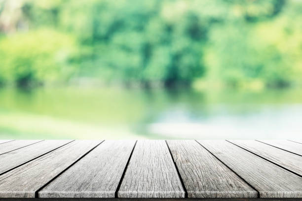 istock Empty wooden table with party in garden background blurred. 902579360