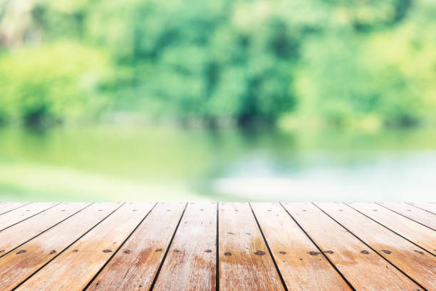 istock Empty wooden table with party in garden background blurred. 902579426
