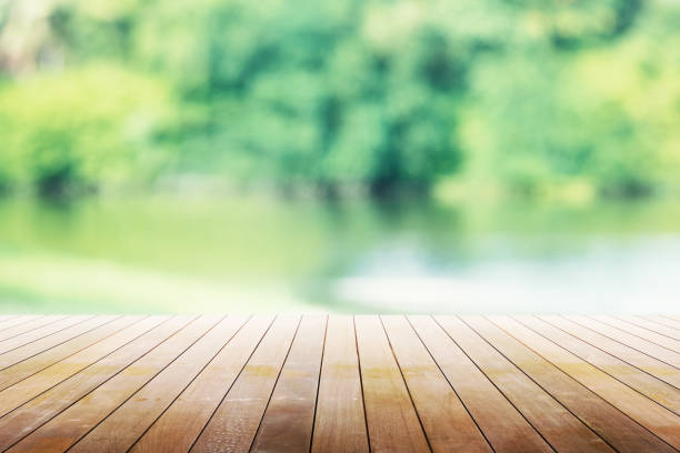 Empty wooden table with party in garden background blurred.