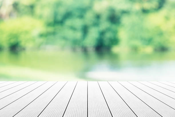 istock Empty wooden table with party in garden background blurred. 902579634
