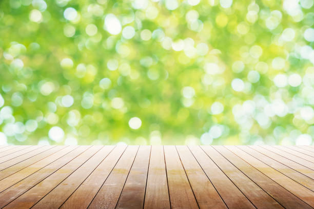 istock Empty wooden table with party in garden background blurred. 902580122