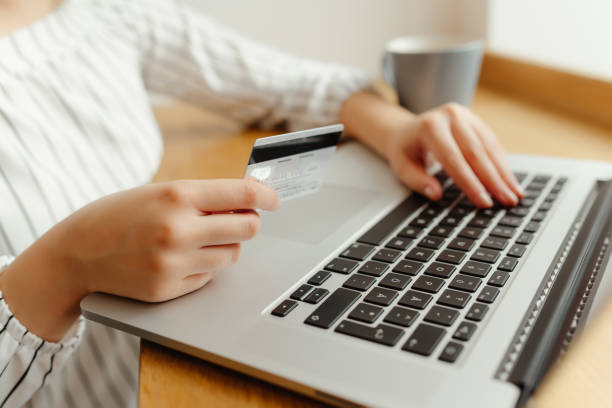 istock Woman with laptop shopping online. Payment Transaction at Computer using Credit Card 902583594