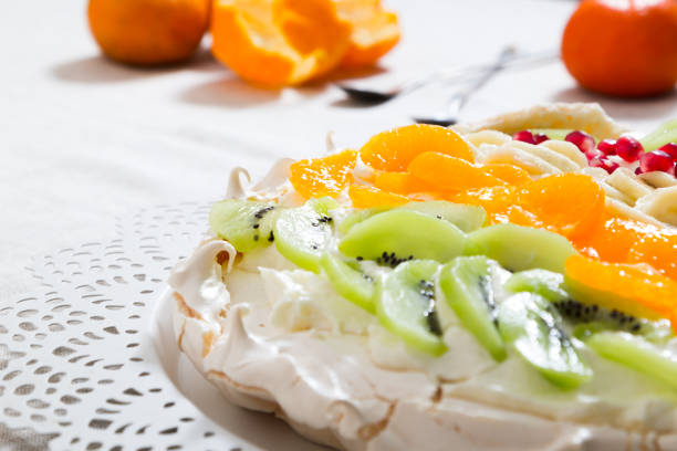 istock Pavlova cake with fruit on a white plate. 902587728