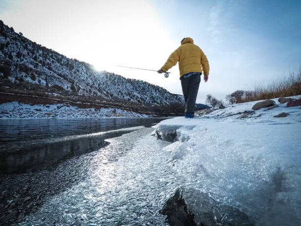 istock Man Winter Fly Fishing 902591048