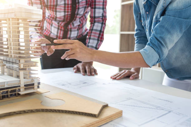 istock Architect working on blueprint, Engineer meeting working with partner colleagues and engineering tools for architectural project, Construction concept 902591676
