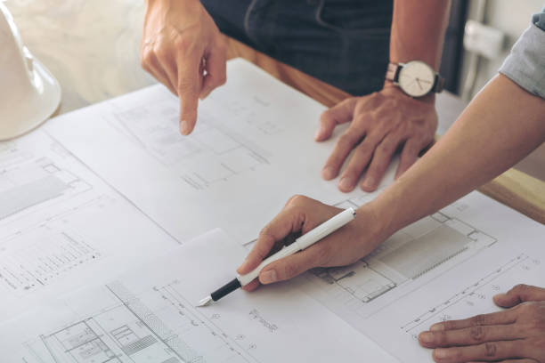 istock Image of engineer or architectural project, Close up of hands architects engineering working on blueprint with engineering equipment tool, Construction concept 902591984