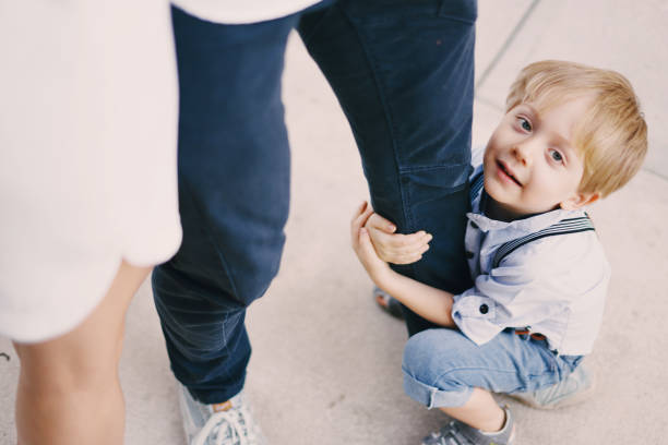 beautiful young family dad mom and a little boy with blond hair walking around the city and enjoying the sunshine, multi family black and white three way kiss stock pictures, royalty-free photos & images