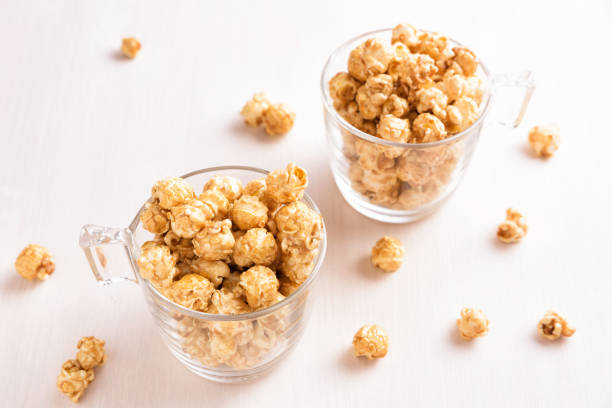 istock Two glasses of caramel popcorn. 902594648