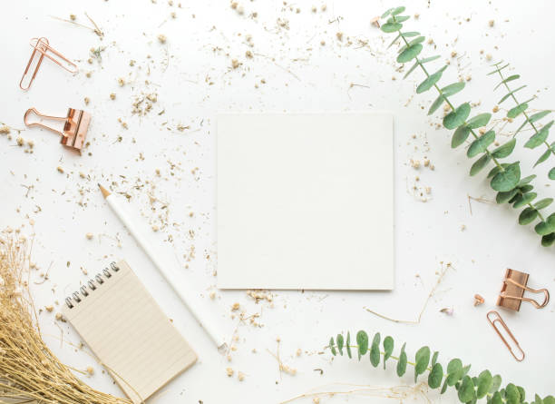 istock Top view of white paper on worktable with accessories 902596078