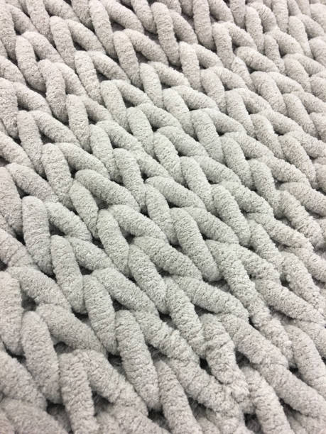 istock Knitting from thick soft yarn of gray color. Textile background. 902596870