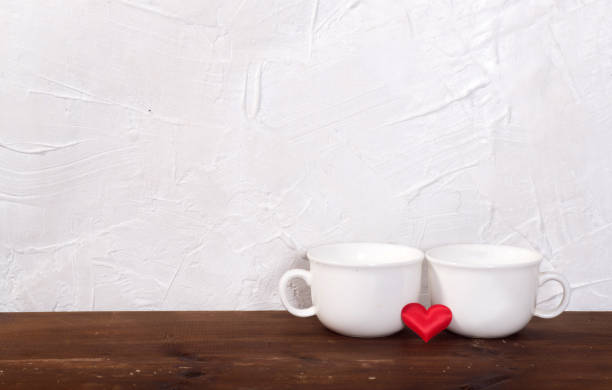 istock Valentine's day holiday celebration with hearts and cups over bokeh background 902601512