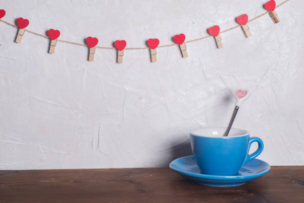 istock Valentine's day holiday celebration with hearts and cups over bokeh background 902601934