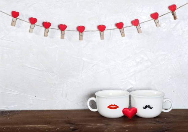 istock Valentine's day holiday celebration with hearts and cups over bokeh background 902602108