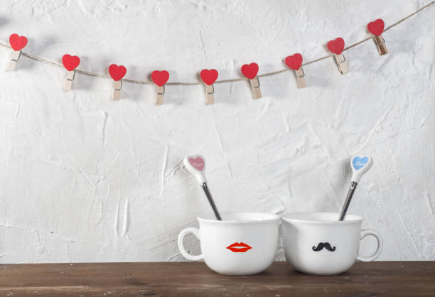 istock Valentine's day holiday celebration with hearts and cups over bokeh background 902602238