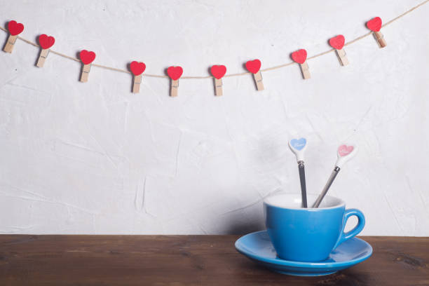 istock Valentine's day holiday celebration with hearts and cups over bokeh background 902602308
