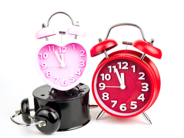 istock Three alarm clock, red, pink, black isolated on white background 902602384