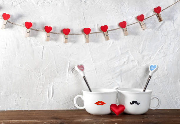 istock Valentine's day holiday celebration with hearts and cups over bokeh background 902602398