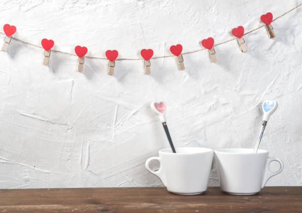 istock Valentine's day holiday celebration with hearts and cups over bokeh background 902602542
