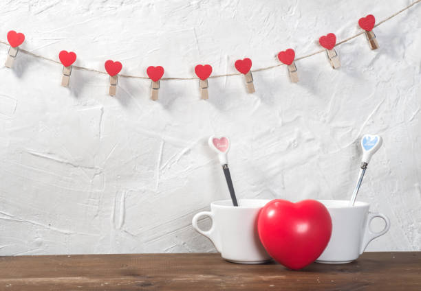 istock Valentine's day holiday celebration with hearts and cups over bokeh background 902604690