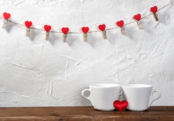 istock Valentine's day holiday celebration with hearts and cups over bokeh background 902604708