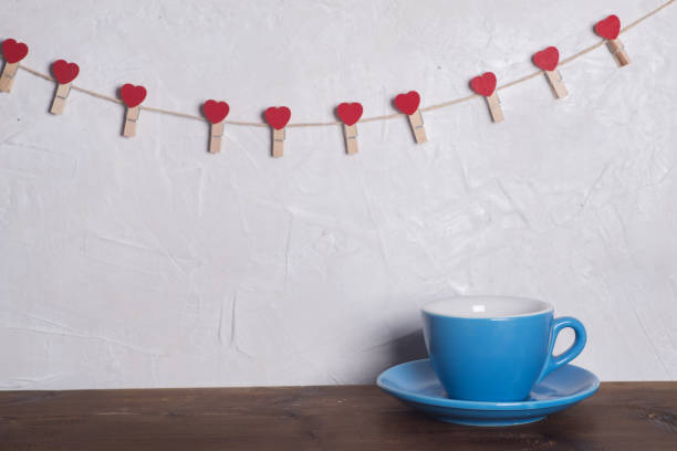istock Valentine's day holiday celebration with hearts and cups over bokeh background 902604868