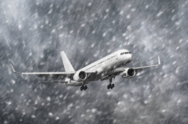 istock Airplane approaching on a landing in snowstorm bad weather. 902607158
