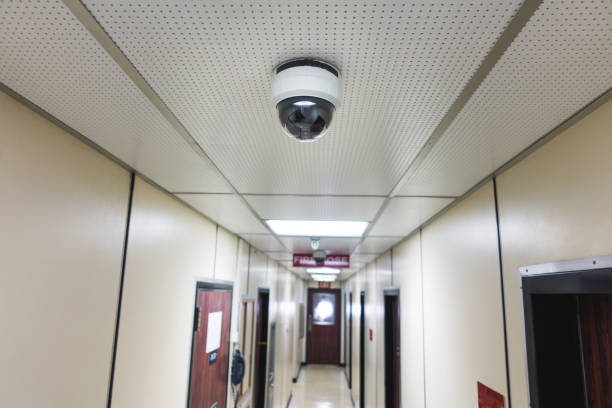 CCTV system security camera or cctv camera on ceiling in apartment room or living quarter. stock photo