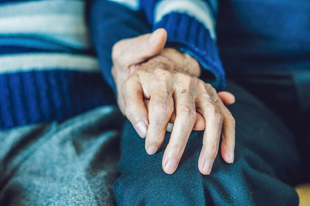 istock Old woman holding an old man's hand 902610470