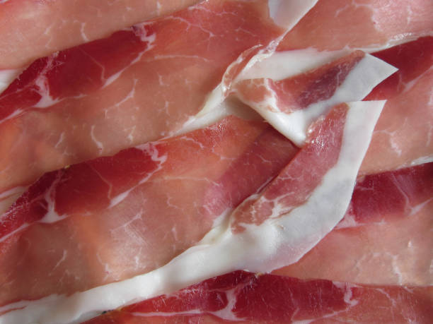istock Rustic ham prosciutto as background . Fresh cold cuts from Tuscany, Italy 902613466