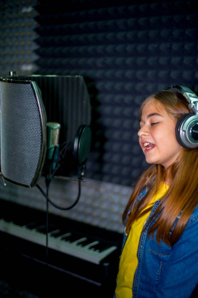 istock Girl in a recording studio 902616794