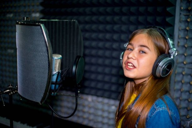 istock Girl in a recording studio 902616870