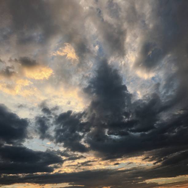 istock beautiful storm sky with clouds background. Dark sky with clouds weather nature cloud storm. Dark sky with clouds and sun. 902617160