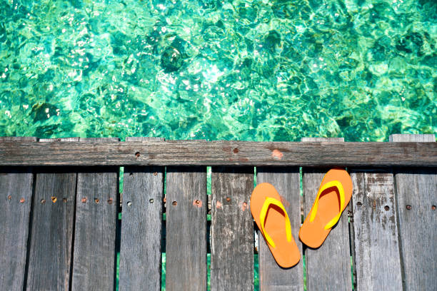 istock Sandals on the beautiful beach - summer vacation 902617604