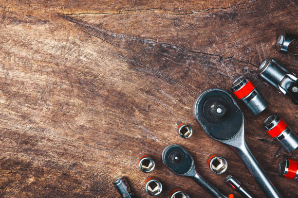 istock Top view of Working tools,wrench,socket wrench,hammer,screwdriver,plier,electric drill,tape measure,machinist square and safety glasses on wooden background.flat lay design for construction concept. 902620020