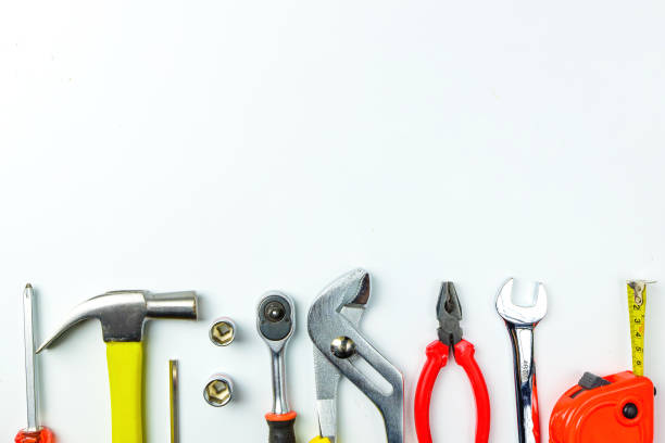 istock Top view of Working tools,wrench,socket wrench,hammer,screwdriver,plier,electric drill,tape measure,machinist square and safety glasses on white background.flat lay design for construction concept. 902620110