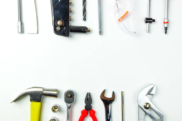 istock Top view of Working tools,wrench,socket wrench,hammer,screwdriver,plier,electric drill,tape measure,machinist square and safety glasses on white background.flat lay design for construction concept. 902620196