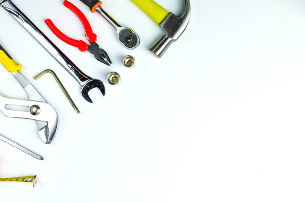 istock Top view of Working tools,wrench,socket wrench,hammer,screwdriver,plier,electric drill,tape measure,machinist square and safety glasses on white background.flat lay design for construction concept. 902620202